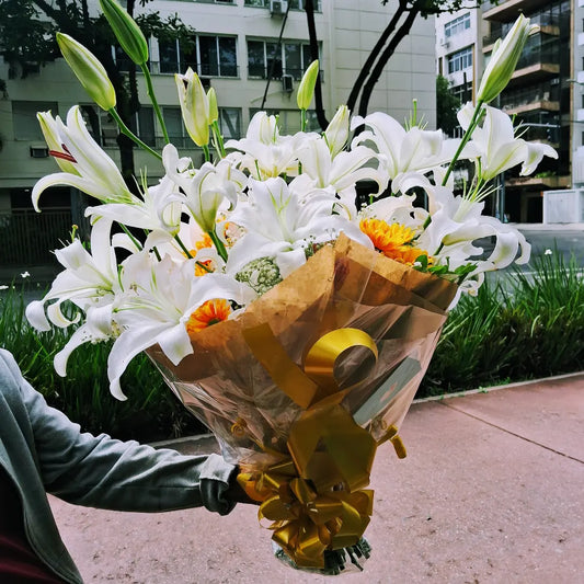 Buquê de lírios brancos com margaridas laranjas